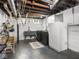 Spacious basement with laundry area, painted walls, and exposed ceiling at 5342 Central Ave, Indianapolis, IN 46220