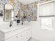 Charming bathroom with double sink vanity, and large arched mirrors, and orange floral wallpaper at 5342 Central Ave, Indianapolis, IN 46220