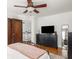 Stylish bedroom featuring dark wood furnishings, a ceiling fan, and large windows for a comfortable living space at 5342 Central Ave, Indianapolis, IN 46220