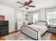 Cozy bedroom with a metal frame bed, soft rug, and natural light creating a relaxing retreat at 5342 Central Ave, Indianapolis, IN 46220