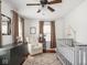 Comfortable bedroom featuring neutral color palette, three large windows, and wooden floor at 5342 Central Ave, Indianapolis, IN 46220