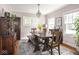 Charming dining room with rustic wooden table, chandelier, and light pink walls creates a cozy and inviting space at 5342 Central Ave, Indianapolis, IN 46220