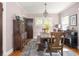 Elegant dining room with traditional wooden table, chandelier, and light pink walls creates a warm and inviting ambiance at 5342 Central Ave, Indianapolis, IN 46220