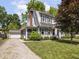 Charming two-story home with a screened-in porch and well-manicured lawn and landscaping at 5342 Central Ave, Indianapolis, IN 46220