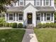 Inviting front entrance featuring a classic black door, beautiful wreath, and manicured landscaping at 5342 Central Ave, Indianapolis, IN 46220