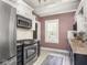 Updated kitchen featuring stainless steel appliances, granite countertops, and tile backsplash, offering style and functionality at 5342 Central Ave, Indianapolis, IN 46220