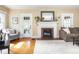 Bright living room featuring a fireplace, neutral-toned walls, and comfortable seating arrangements at 5342 Central Ave, Indianapolis, IN 46220