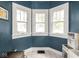 Charming playroom features natural light, blue walls, and a whimsical play kitchen, perfect for creative play at 5342 Central Ave, Indianapolis, IN 46220