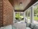 Relaxing screened-in porch with comfortable wicker seating and a view of the surrounding yard at 5342 Central Ave, Indianapolis, IN 46220