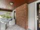 Relaxing screened-in porch with comfortable wicker seating and a view of the surrounding yard at 5342 Central Ave, Indianapolis, IN 46220