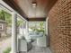 Relaxing screened-in porch with comfortable wicker seating and a view of the surrounding yard at 5342 Central Ave, Indianapolis, IN 46220
