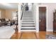 Elegant staircase with hardwood floors, white risers, and decorative details leading to the upper level at 5342 Central Ave, Indianapolis, IN 46220