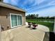Back patio with lawn view, outdoor chairs, and a sliding door leading to the interior at 5379 Marigold Dr, Plainfield, IN 46168