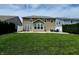 Backyard features a well-maintained lawn, privacy fence, and patio furniture at 5379 Marigold Dr, Plainfield, IN 46168