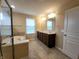 Bathroom featuring double sinks, a soaking tub, and a walk-in shower with glass door at 5379 Marigold Dr, Plainfield, IN 46168