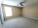 A clean, empty carpeted bedroom featuring a ceiling fan and a bright window at 5379 Marigold Dr, Plainfield, IN 46168