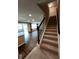 Staircase and entryway lead to the kitchen and living area with hardwood flooring at 5379 Marigold Dr, Plainfield, IN 46168
