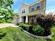 Charming two-story home featuring a brick facade, well-manicured landscaping, and inviting front porch seating area at 5379 Marigold Dr, Plainfield, IN 46168