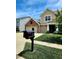 Traditional two-story home with brick and siding exterior, three-car garage, and well-kept front lawn and mailbox at 5379 Marigold Dr, Plainfield, IN 46168