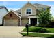 Charming two-story home with a three car garage, brick accents, and well-maintained landscaping at 5379 Marigold Dr, Plainfield, IN 46168