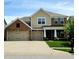 Classic two-story home with brick and siding, a three-car garage, and a neatly maintained front yard at 5379 Marigold Dr, Plainfield, IN 46168