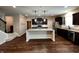 A spacious kitchen features a large island, stainless steel appliances, and dark cabinetry at 5379 Marigold Dr, Plainfield, IN 46168