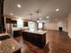 Kitchen features a large island and stainless appliances, flowing into the adjacent living area at 5379 Marigold Dr, Plainfield, IN 46168