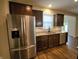 Kitchen featuring stainless steel refrigerator, granite countertops, and dark cabinetry at 5379 Marigold Dr, Plainfield, IN 46168