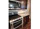 A close up of the oven, microwave, countertops, and cabinets in the kitchen at 5379 Marigold Dr, Plainfield, IN 46168