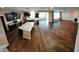 A wide shot of open kitchen with island that flows into the living room with fireplace at 5379 Marigold Dr, Plainfield, IN 46168