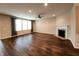 Spacious living room with hardwood floors, a fireplace, and large windows offering natural light at 5379 Marigold Dr, Plainfield, IN 46168