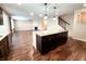 The kitchen island overlooks the living room featuring a fireplace and stair access at 5379 Marigold Dr, Plainfield, IN 46168