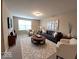 Bright living room featuring modern furniture, neutral tones, and a large area rug at 5379 Marigold Dr, Plainfield, IN 46168