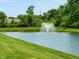 A tranquil pond with a fountain, surrounded by a lush, green lawn at 5379 Marigold Dr, Plainfield, IN 46168