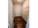 A spacious walk-in closet featuring shelving and wood-look flooring at 5379 Marigold Dr, Plainfield, IN 46168