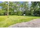 Spacious backyard featuring a large grassy area with mature trees and surrounding greenery at 5506 Kessler Blvd N Dr, Indianapolis, IN 46228