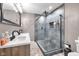 Modern bathroom featuring a double sink vanity and a walk-in shower with glass enclosure, offering a spa-like experience at 5506 Kessler Blvd N Dr, Indianapolis, IN 46228