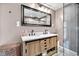 Modern bathroom featuring a double sink vanity and a walk-in shower with glass enclosure, offering a spa-like experience at 5506 Kessler Blvd N Dr, Indianapolis, IN 46228