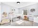Charming bedroom featuring a cozy loft bed, plush carpet, and natural light streaming through a window overlooking the backyard at 5506 Kessler Blvd N Dr, Indianapolis, IN 46228