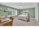 Cozy bedroom with a large window providing ample natural light, complemented by neutral tones and comfortable carpeting at 5506 Kessler Blvd N Dr, Indianapolis, IN 46228