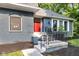 Inviting entrance with steps, wrought iron railings and red door at 5506 Kessler Blvd N Dr, Indianapolis, IN 46228