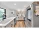 Bright kitchen featuring white cabinets, stainless steel appliances, and a functional layout at 5506 Kessler Blvd N Dr, Indianapolis, IN 46228