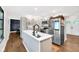 Charming kitchen with stainless steel appliances, white cabinets, and a spacious island at 5506 Kessler Blvd N Dr, Indianapolis, IN 46228