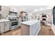 Modern kitchen with stainless appliances, island, and bright countertops at 5506 Kessler Blvd N Dr, Indianapolis, IN 46228