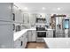 Beautiful, well-organized kitchen with stainless steel appliances, white cabinets, and ample counter space at 5506 Kessler Blvd N Dr, Indianapolis, IN 46228