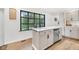Bright eat-in kitchen featuring a spacious island, white cabinets, and stainless steel appliances at 5506 Kessler Blvd N Dr, Indianapolis, IN 46228