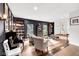 Comfortable living area featuring piano, hardwood floors, and neutral tones at 5506 Kessler Blvd N Dr, Indianapolis, IN 46228