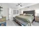 A serene main bedroom offers soft carpet, stylish ceiling fan, and ample storage within the closet at 5506 Kessler Blvd N Dr, Indianapolis, IN 46228