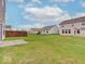 Large backyard featuring a well-maintained lawn and a concrete patio at 5768 Blue Sky Dr, Whitestown, IN 46075
