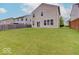 Well-manicured backyard with lush grass, offering ample space for outdoor enjoyment at 5768 Blue Sky Dr, Whitestown, IN 46075